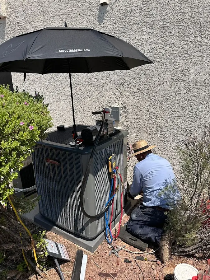 HVAC technician performing outdoor AC maintenance in Barberton
